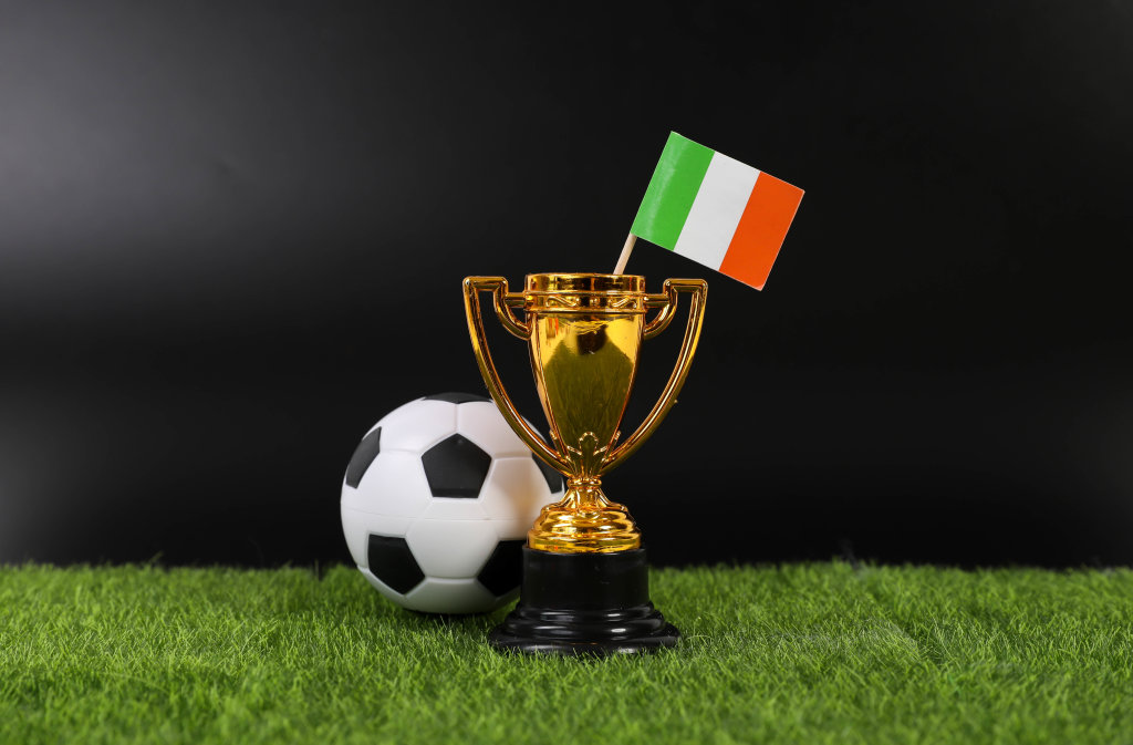 Golden trophy and football ball with flag of Ireland