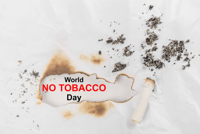 World no tobacco day background with a cigarette butt and ashes