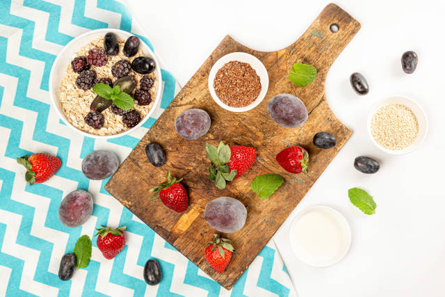 Healthy food background with oatmeal, berries and seeds