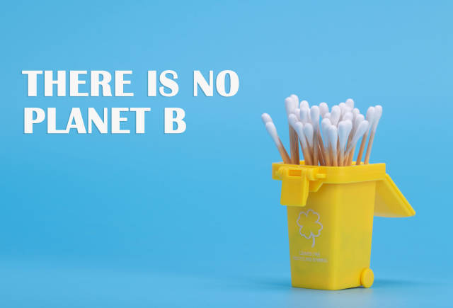 Cotton swabs in a trash can with There is no planet B text