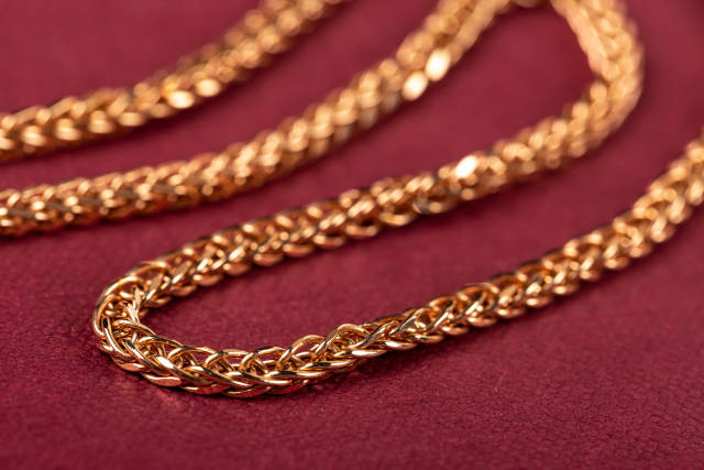 Close up, golden chain weaving anchor