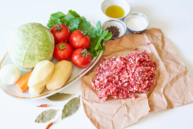 Preparing food with cabbage, minced meat and vegetables