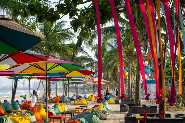 Cho Ca Go Beach Bar with Colorful Bean Bags, Wooden Tables, Sun Umbrellas and Decorations at My Khe Beach in Da Nang, Vietnam