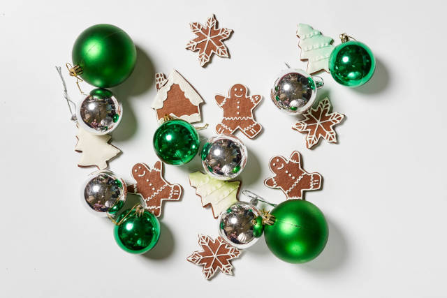 Christmas tree decorations and sweet cookies on white table