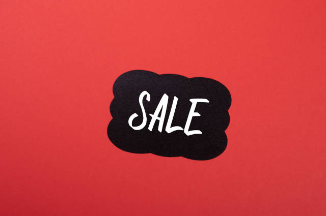 Black sticker with Sale text on red background