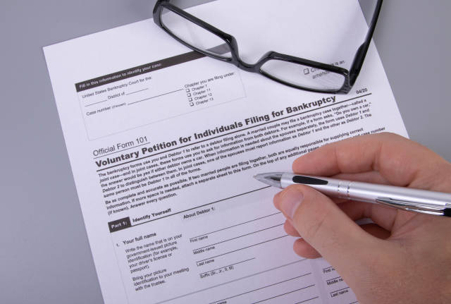 Man filling out Form 101 Voluntary Petition for Individuals Filing for Bankruptcy