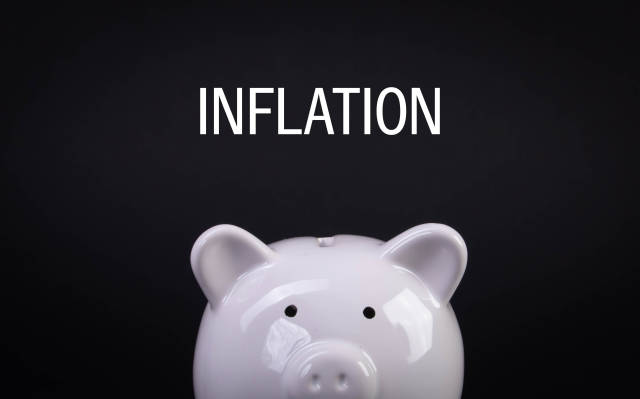 White piggybank with Inflation text on black background
