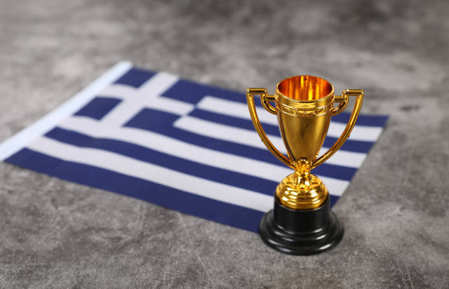 Golden trophy with flag of Greece