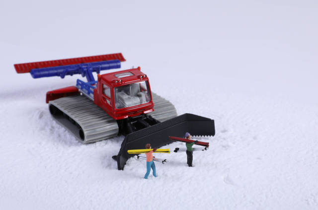 Snowcat ratrack machine and skiers on snow