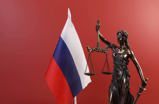 Statue of Lady Justice and flag of Russia on red background