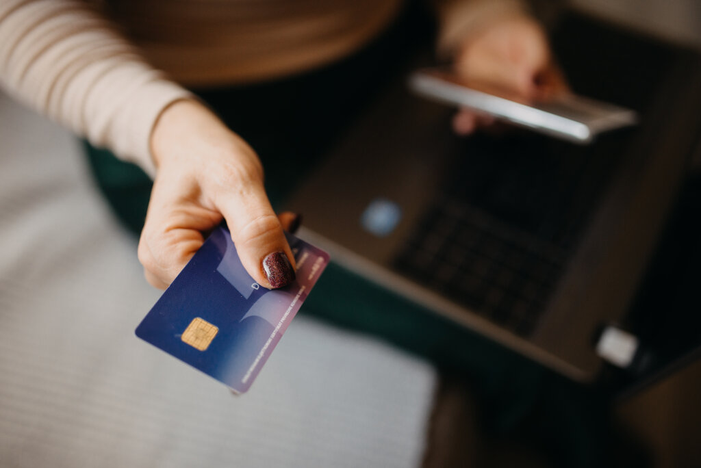Middle-aged woman holding a credit card closeup