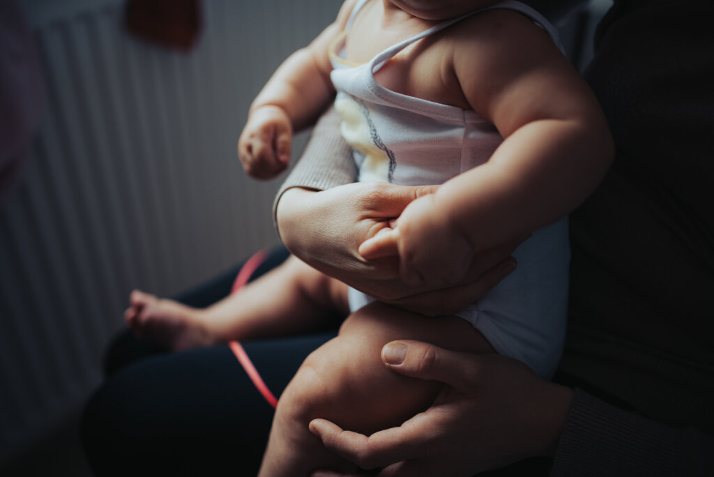 Mother holding her toddler child