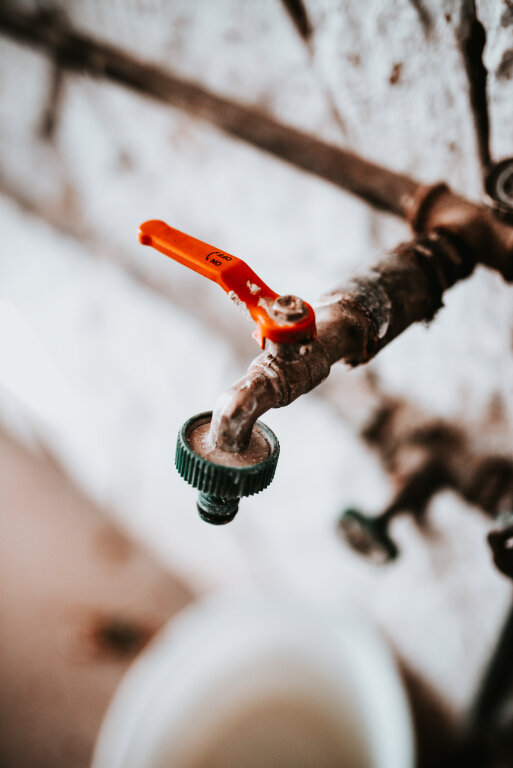 Old iron water tap in garage.