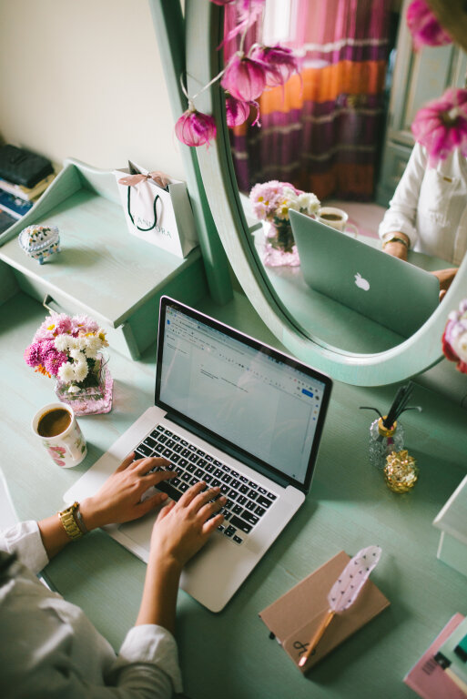 Young woman in her glamour room working on a notebook