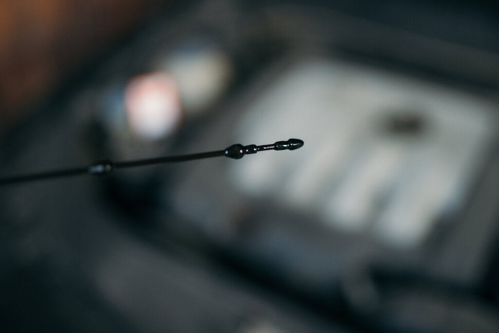 Checking the oil level in a car engine.