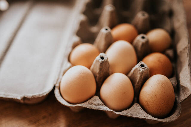 Closeup of the eggs in the cardboard box on the table.