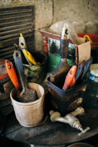 Different colorful brushes in the buckets on the table.