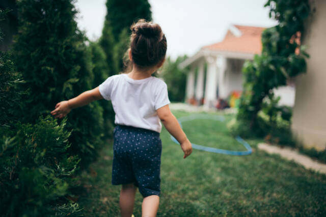 Girl playing in the backyard.