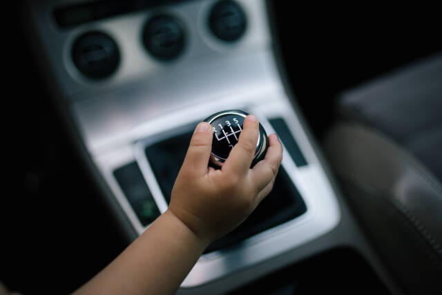 Girl s hand on a gear shifter.