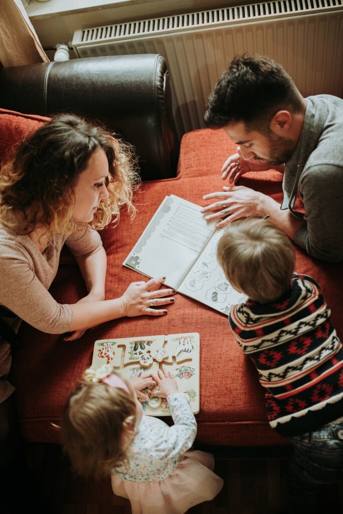 Brother and sister learning with their parents