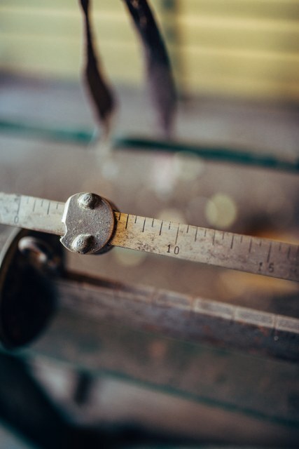 Close view of a vintage measuring tool highlighting precise markings used in craftsmanship